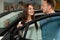 Beautiful couple stay behinde the car door.