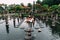 A beautiful couple is traveling on the island of Bali in Indonesia. A couple walks through a water temple in Indonesia.