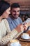 Beautiful couple using telephones at cafe