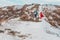 Beautiful couple walks in the phosphate-gypsum white mountains of Ukraine, the girl in a red dress