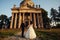 Beautiful couple in wedding dress outdoors near the antique victorian church