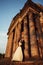 Beautiful couple in wedding dress outdoors near the victorian church