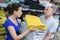 Beautiful couple woman inspecting and buying towels in supermarket