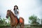 beautiful cowboy girl riding a horse while going