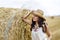 Beautiful cowboy woman Posing near at the haystacks.