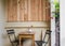 Beautiful cozy terrace or balcony with small table, chair and flowers. Toned image