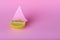 Beautiful creative decoration background idea with fresh fruit lemon yacht, sailboat with sail on pink  background