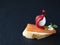 A beautiful creative sandwich is a traditional Spanish tapas snack. The tapas consist of salmon, quail egg, cream cheese, basil