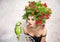 Beautiful creative Xmas makeup and hair style indoor shot. Beauty Fashion Model Girl with green parrot