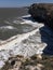 Beautiful Crimean seascape. High cliffs and long foamy waves in sunny day