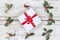 Beautiful Cristmas gifts i the middle of Holly on old white painted cracked wooden background
