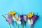 Beautiful crocus flowers on turquoise background, flat lay. Space for text