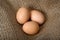 Beautiful crude eggs on burlap. Protein, protein, Top view. Easter