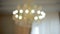 Beautiful crystal chandelier in the background of a window. Vintage lighting lamps with light bulbs and a lot of