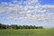 Beautiful cumulus cirrus clouds over field