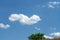 Beautiful cumulus clouds on bright blue sky