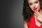 Beautiful curle hair female in red with red lips and dress manicure, beauty red afro hairstyle