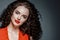 Beautiful curle hair female in red with red lips and dress manicure, beauty red afro hairstyle