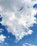 Beautiful curly white cloud in the blue sky in sunny weather, vertical and format