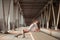 Beautiful curly young woman posing on industrial bridge location