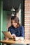 Beautiful cute asian young businesswoman in the cafe, using digital tablet and drinking coffee smiling