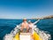 Beautiful and cute couple of seniors or old people in the middle of the sea driving and discovering new places with small boat.