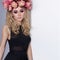 Beautiful cute girl blonde in black fashion long dress and with a wreath on his head in the Studio with bright makeup Smokey