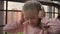 Beautiful cute happy little girl is listening to music on wireless headphones. Funny little girl sings and moves in