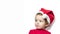 Beautiful cute little girl in red clothes, santa claus hat on white background with copy space. baby dreams of holiday, gifts.