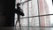 Beautiful dance from a ballerina in a black tutu on a background of city buildings. Ballet. Slow motion. Steadicam shot