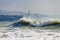 Beautiful and dangerous storm waves on the background of the Gelendzhik lighthouse. Resort Gelendzhik, Caucasus, steep rocky shore