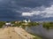 Beautiful dark blue thundercloud over the city. Top view of the city, churches, bridge, river. Aerial photography.