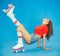 Beautiful dark-haired woman posing lifting leg up in denim shorts and a red top on vintage roller derby summer day on