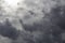 Beautiful day cloudscape view from below of dramatic dramatic grey and white thunder storm clouds on a dark sky background