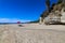 A beautiful day on a gorgeous sandy beach with people relaxing on the beach with blue sky