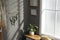 Beautiful decor element made of dry bamboo stick and eucalyptus branches hanging on grey wall in hallway