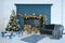 Beautiful decor of the holiday happy new year with prepared wood for the fireplace and the inscription of a happy new