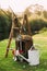 Beautiful decor with old watering cans, wooden ladder and shelves by the river