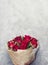 Beautiful deep red rose bouquet on grey concrete background. Valentine`s day, wedding decor