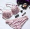Beautiful delicate lingerie, panties and bra on white background with perfume