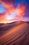 beautiful desert dune hills at dramatic purple sunset