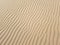 Beautiful desert sand background with wind ripples lines or waves effects