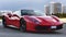 Beautiful design of luxury model sports red supercar Ferrari 488 GTB in a beautiful sunny day