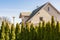 Beautiful detached house surrounded by conifers in the nature as a land boundary