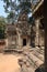 Beautiful, detailed murals on ancient temple ruins, religon symbols in angkor wat on red brown sand, trees in background