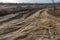 Beautiful dirt and gravel dust road path on the highland of Europe. A muddy rough terrain for an extreme 4WD 4x4 car. Sand dune