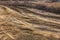 Beautiful dirt and gravel dust road path on the highland of Europe. A muddy rough terrain for an extreme 4WD 4x4 car. Sand dune