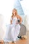 Beautiful disabled bride posing in a wheelchair against the background of a panoramic window overlooking the skyscrapers