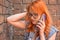 Beautiful disappointed redhead Caucasian girl talking on smart phone