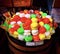 Beautiful display of colorful macarons with metal tongs at a shop